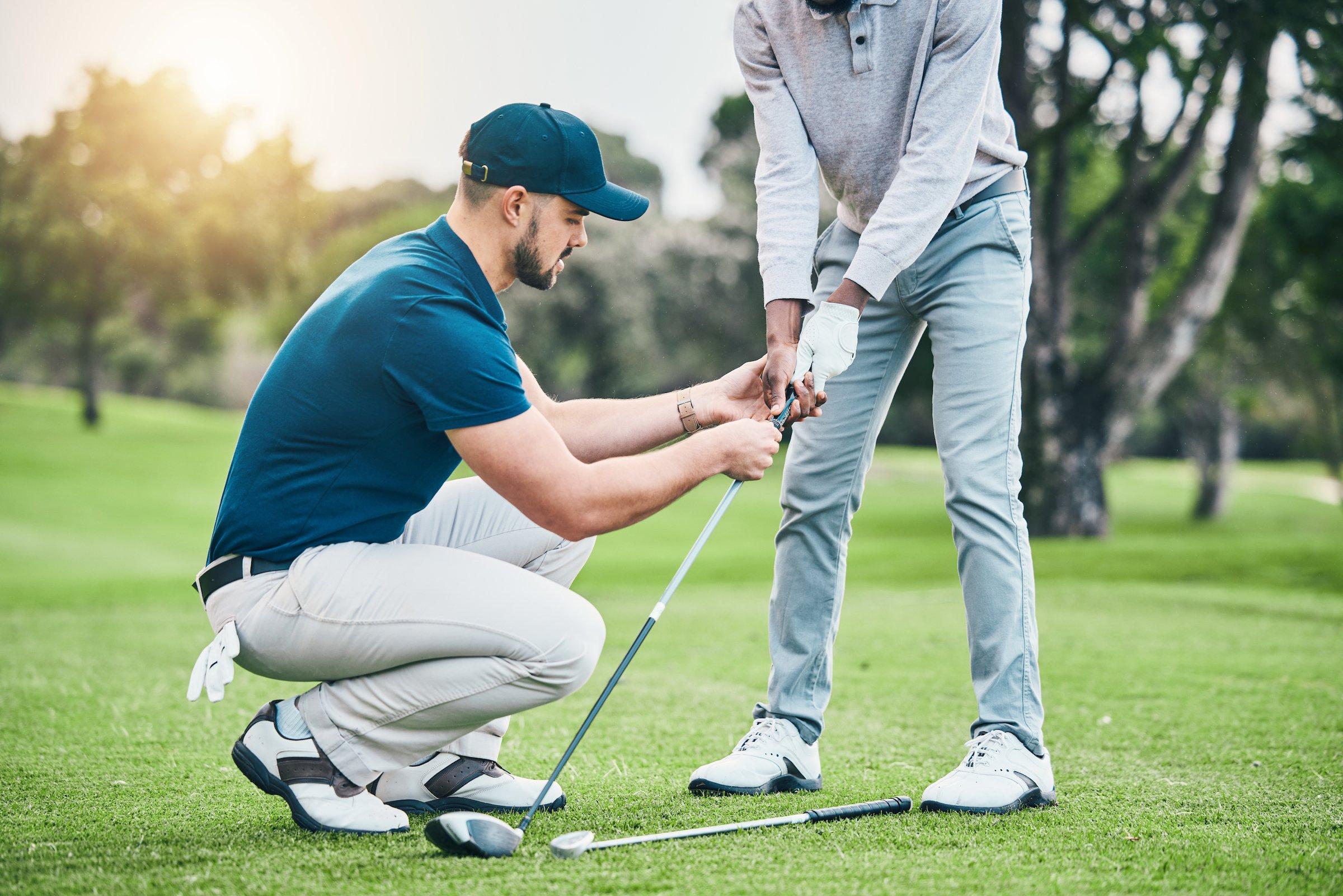 An instructor teaching a person how to golf at Black Desert Golf Course