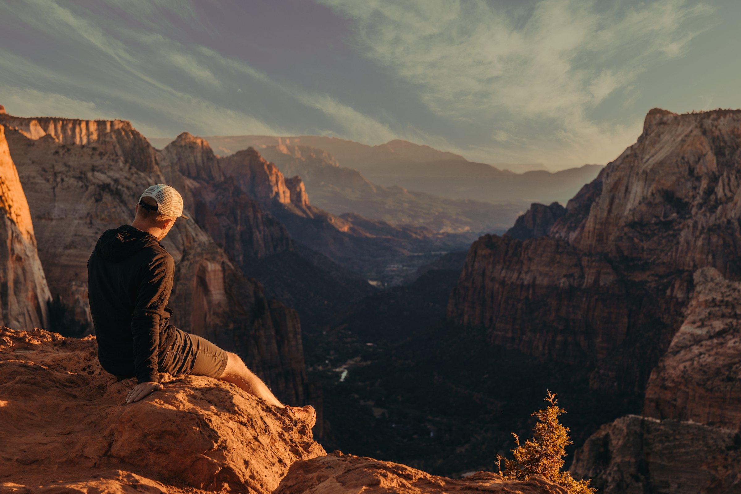 A man sitting on top of mountains near Black Desert Resort