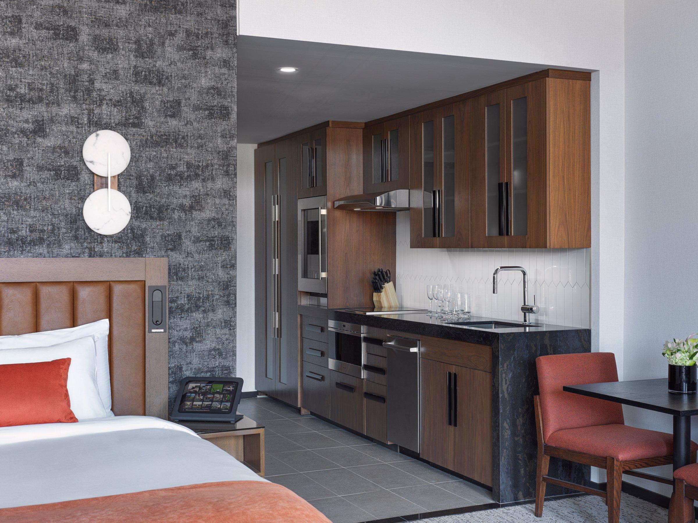 Bed and kitchen of a 2 bedroom suite at Black Desert Resort