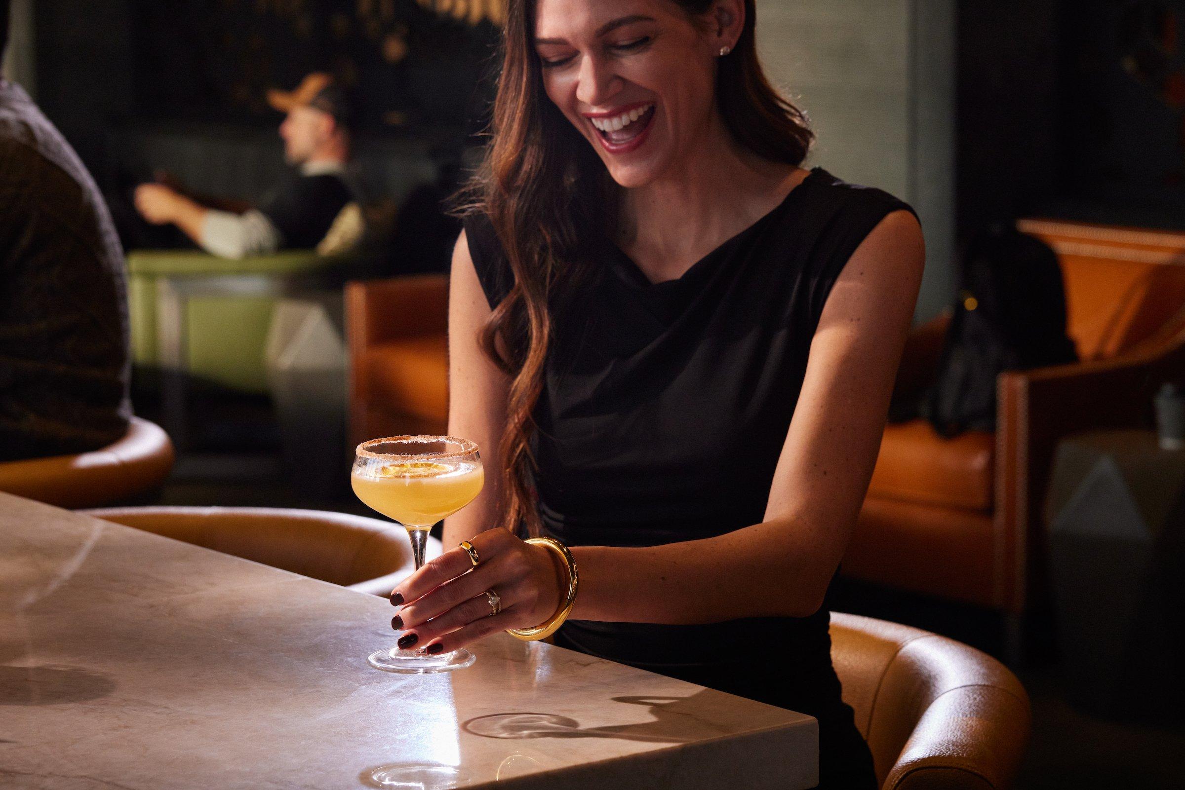 A woman with a cocktail at Flo restaurant