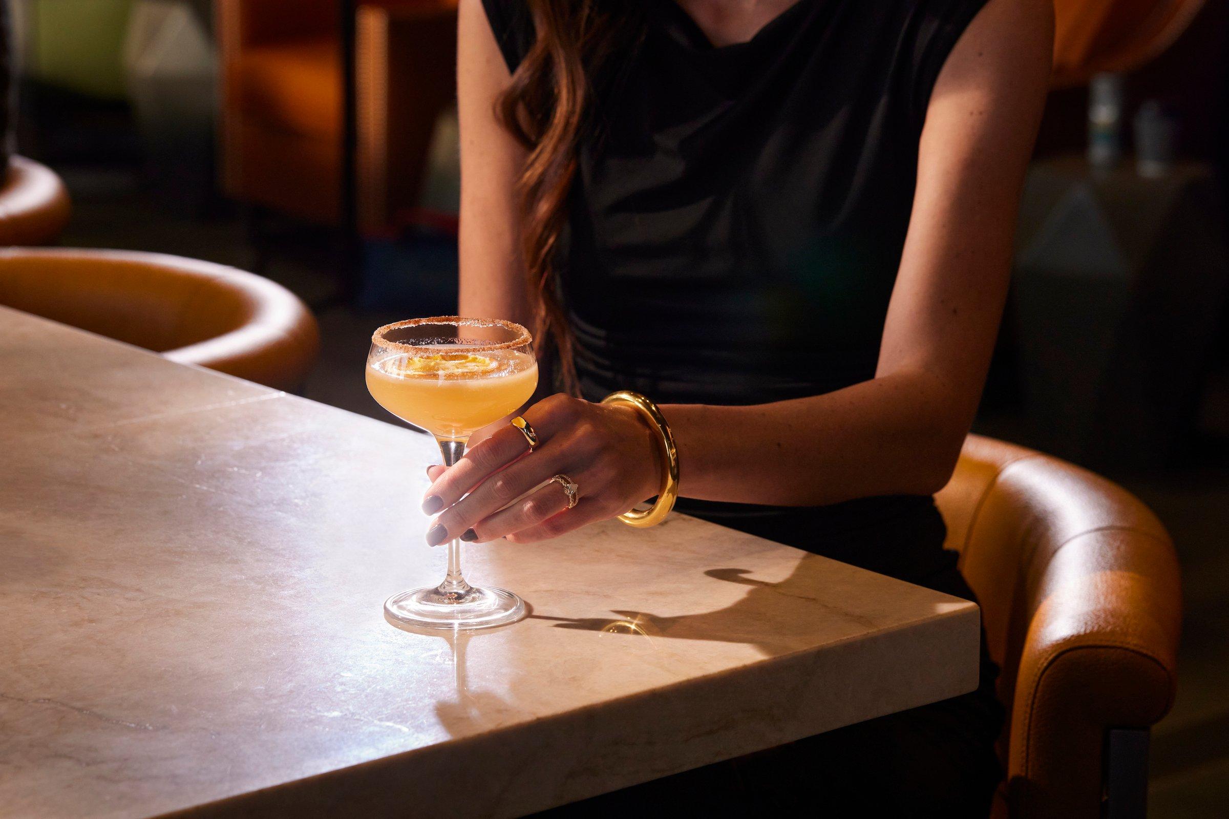 A woman with a cocktail at Flo restaurant
