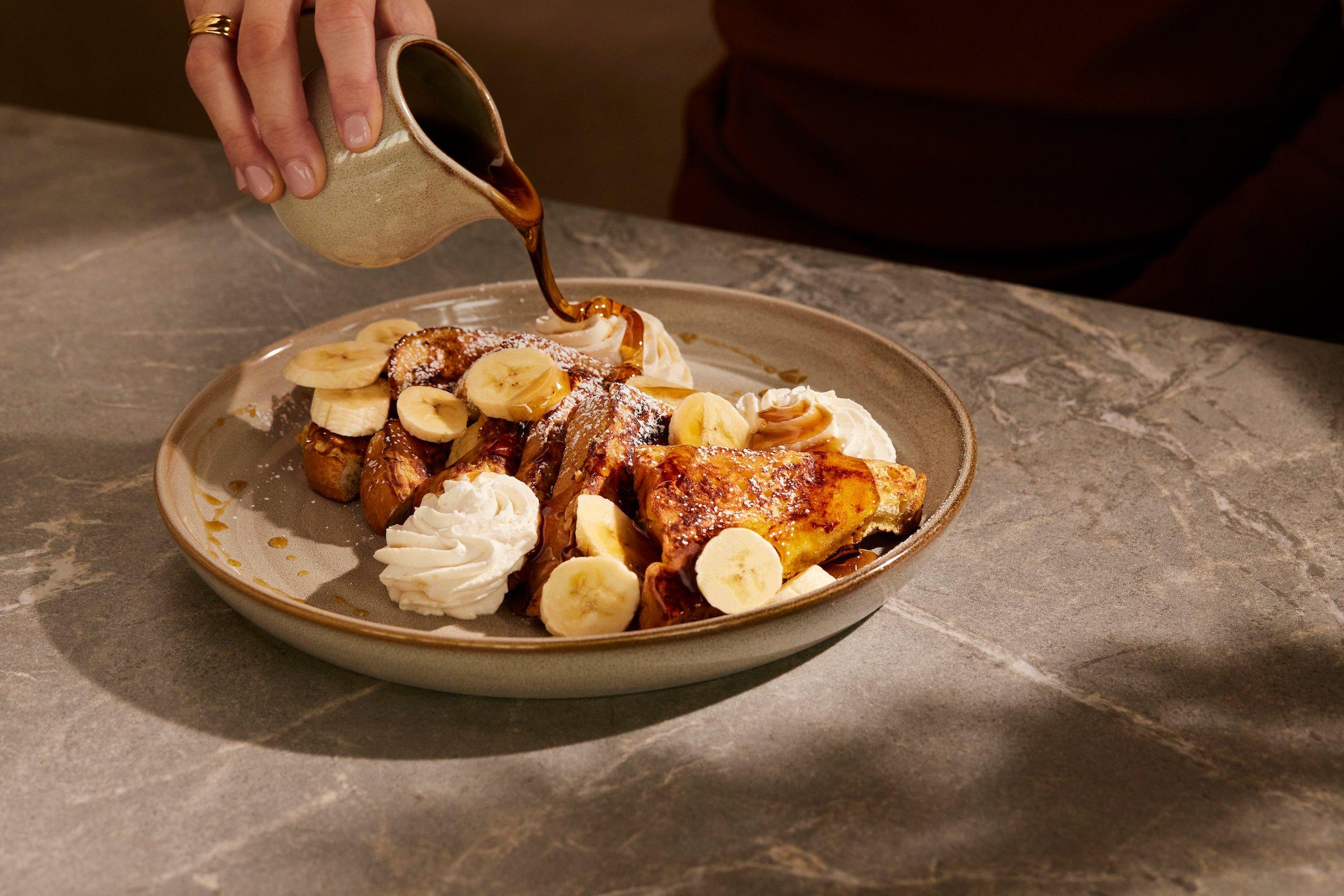 French toast with bananas, whipped cream, and maple syrup at Latitude restaurant
