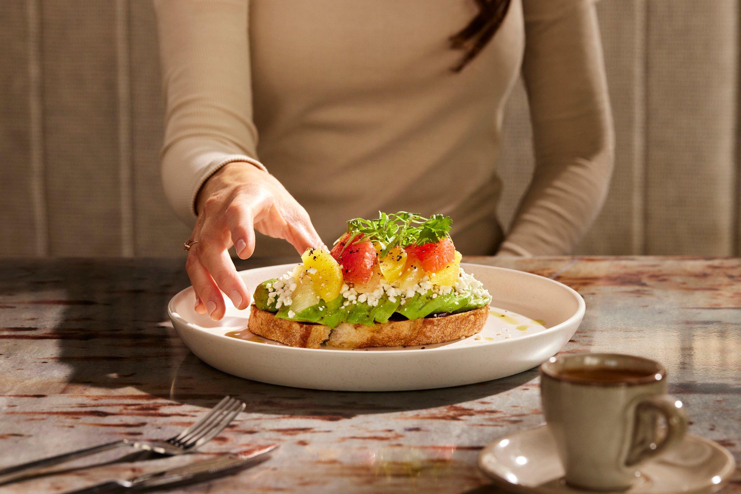 A woman eating a dish at Latitude at Black Desert Resort