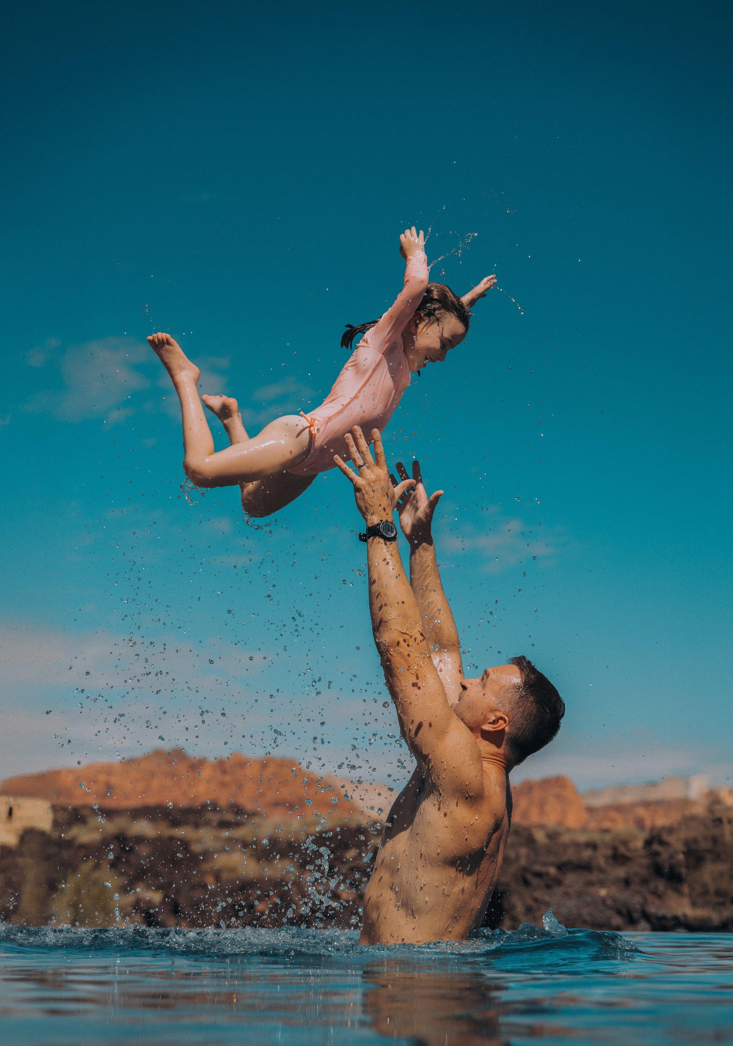 A man and his daughter swimming at Black Desert Resort