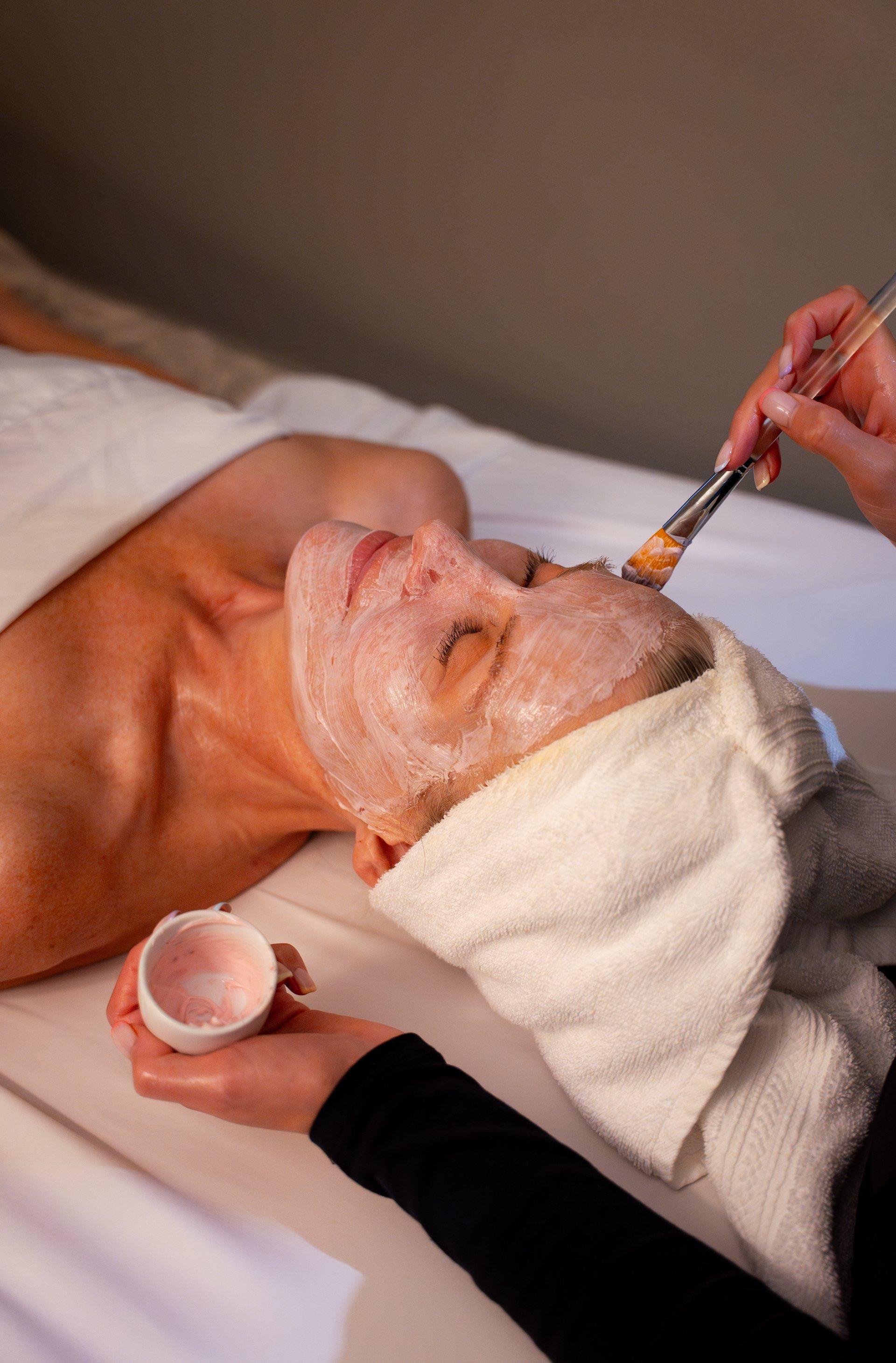 A guest unwinds with a rejuvenating facial at the serene luxury spa at Black Desert Resort, a premier wellness destination in Utah.