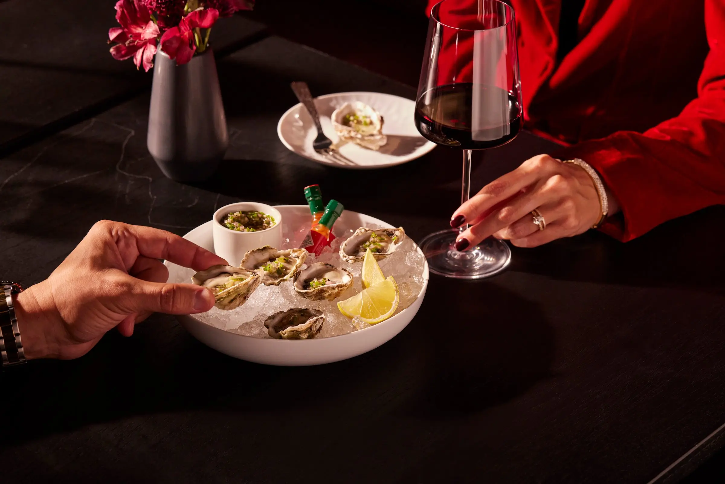 Two people sharing oysters at Black Desert Resort