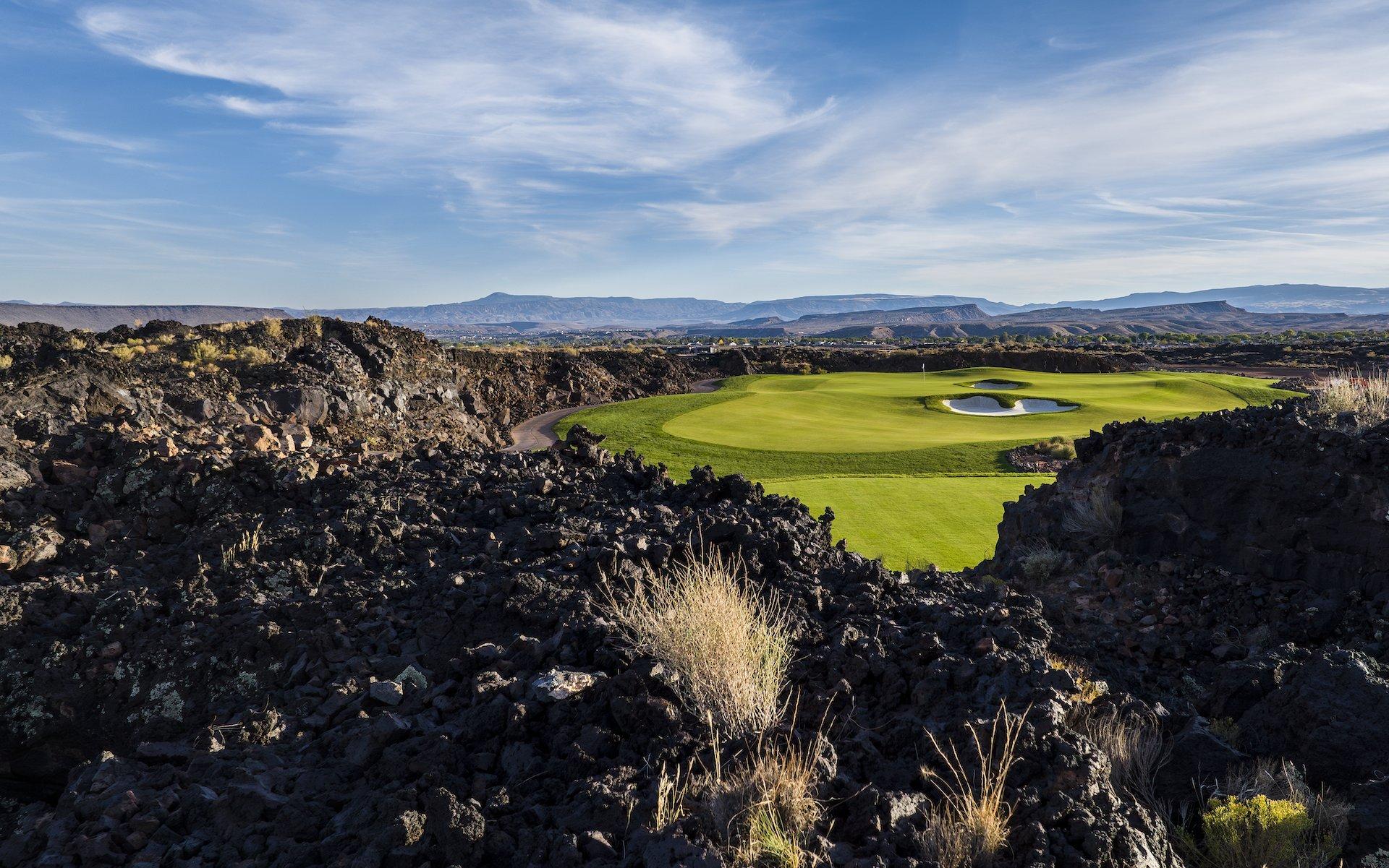 A panoramic view of the unique lighted putting course at Black Desert Resort, a perfect venue for evening golf and entertainment against a mountain backdrop.
