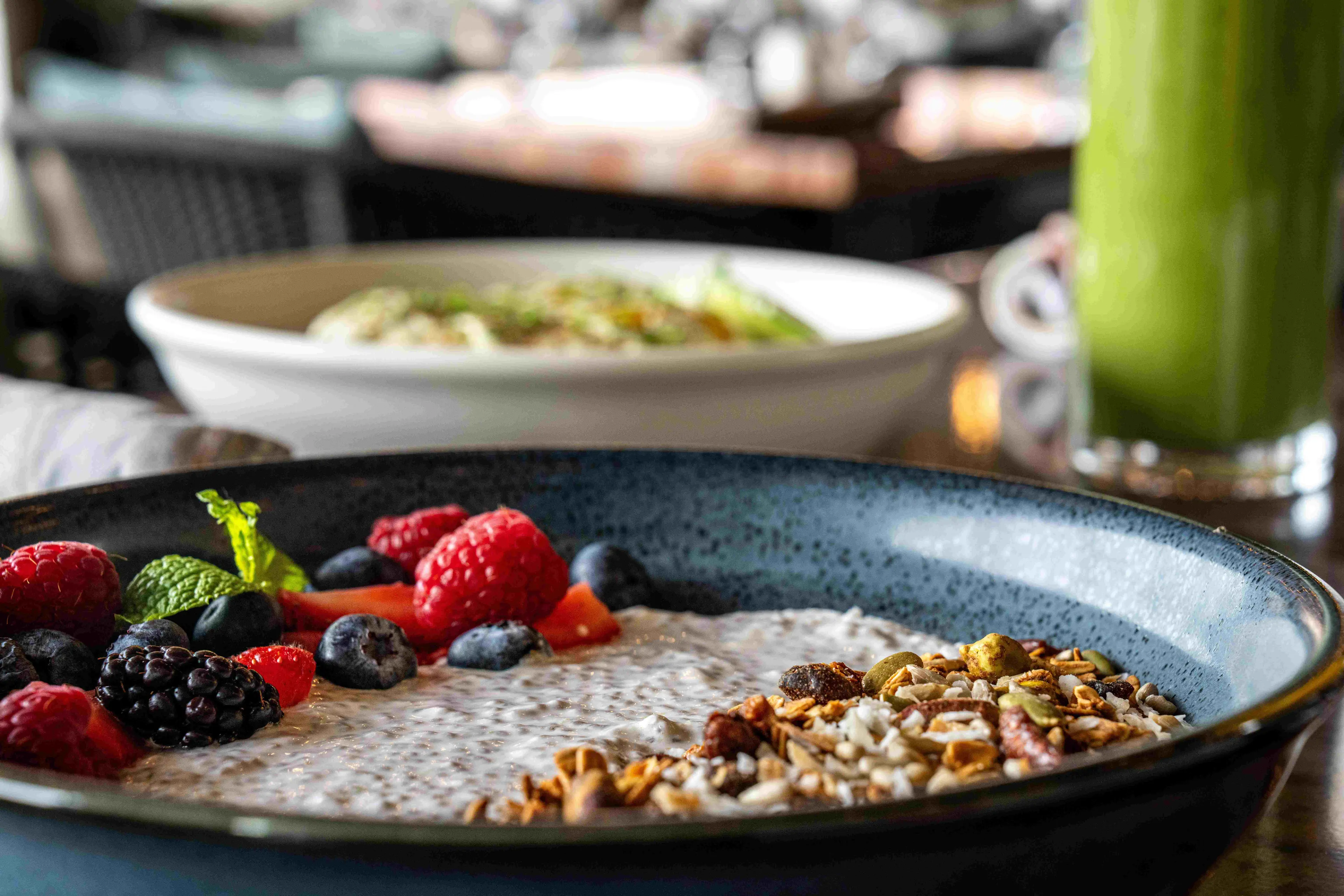 A healthy and delicious chia seed pudding bowl topped with fresh berries and granola, served at a restaurant at Black Desert Resort.