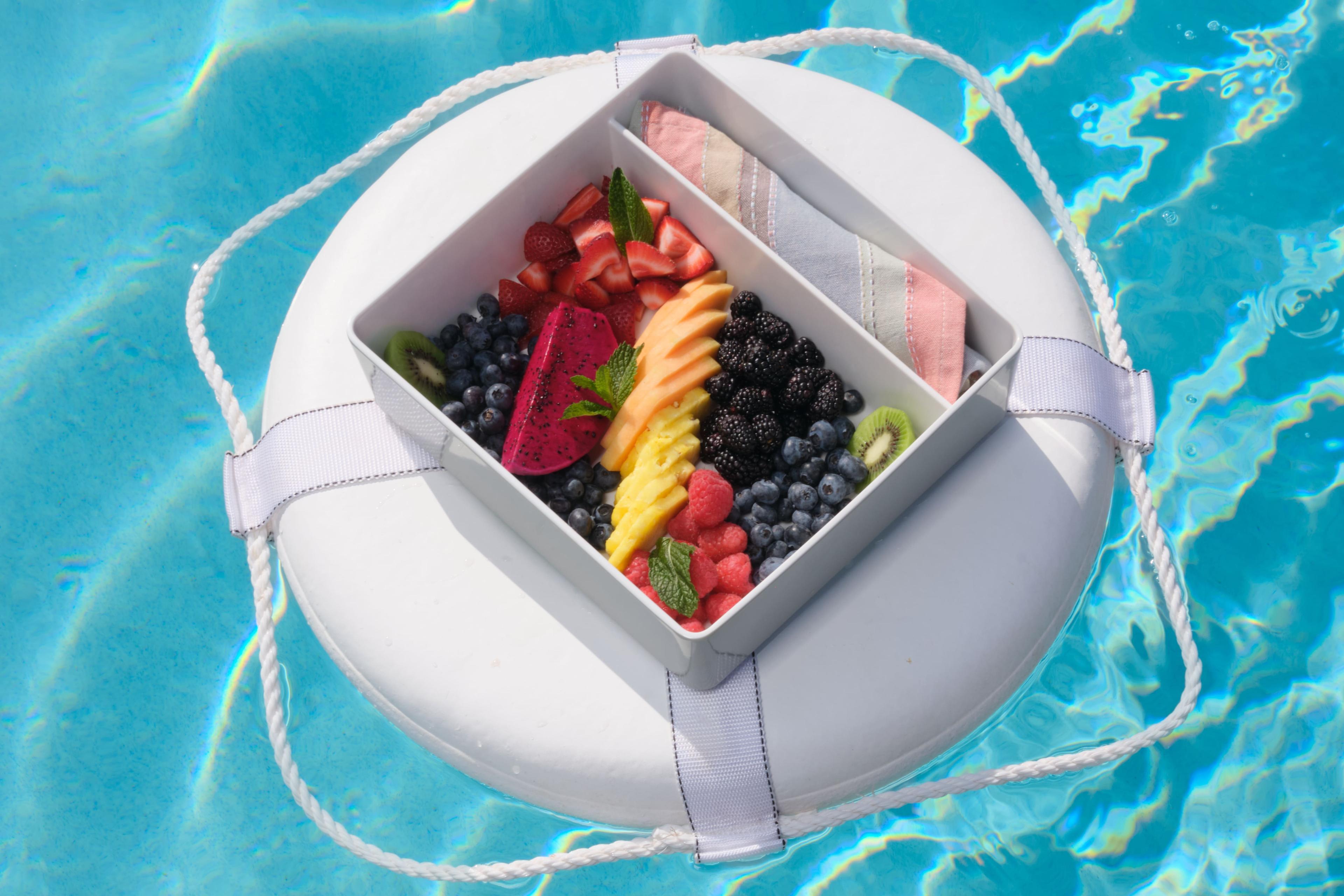 A floating tray of food at the pool of Black Desert Resort